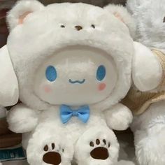 two white stuffed animals sitting next to each other