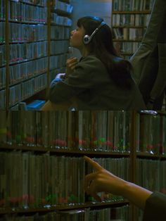 a woman with headphones on in front of a book shelf filled with books and cds