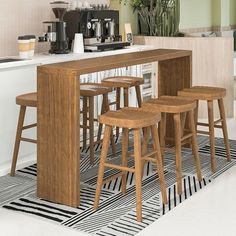 an image of a kitchen setting with barstools and stools on the floor