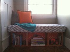 a window seat with books on it in the corner