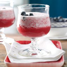 two glasses filled with red, white and blue dessert