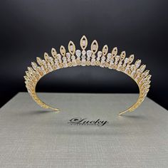 Our beautiful Bridal Halo Crown, perfect for Quinceaneras and all special occasions. With both high and low peaks, this Halo Tiara adds a brilliant and tasteful touch to any hair style. Stay on trend and make a statement with this fresh must-have accessory of the season. High Quality Rectangular, Round and Marquise CZ gems. Handcrafted with highest quality Zirconia jewels and rhodium plated to prevent tarnish and scratch. 1 inch central height tapering to 0.5 inch on the sides all around ear to ear design. Ideal for Wedding, Bridal Hair, Anniversary, Quinceanera, Prom, Pageant and Special Occasions. Each Lucky Collections ™ tiara comes in custom luxury box for convenient presentation and keepsake. Loops on both ends of the Headpiece for stability and security Fast and Free Shipping from Lo Tiara For Quinceanera, Halo Tiara, Crown Halo, Wedding Bridal Hair, Royalty Fashion, Bridal Halo, Halo Crown, Ear Design, Wedding Hair Accessories