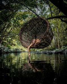 a woman is in the water with a large wicker basket hanging from her back