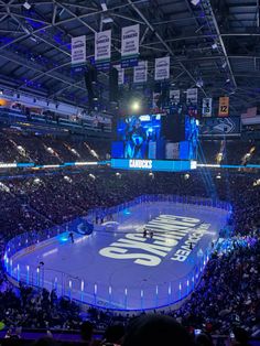 an ice hockey arena filled with lots of people