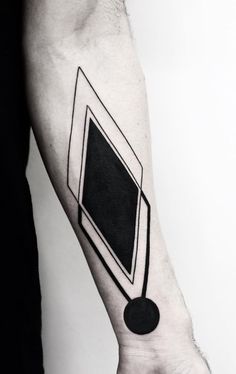 a black and white photo on the arm of a man with a geometrical tattoo