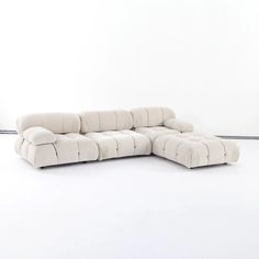 a white couch sitting on top of a white floor