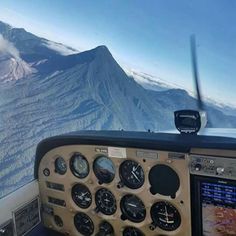 the view from inside an airplane looking at mountains