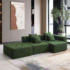 a large green couch sitting on top of a white rug in a living room next to a window