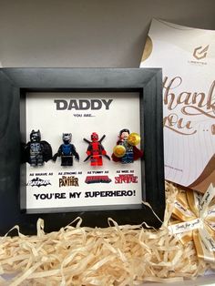 there are three legos in a shadow box with the words daddy you're my superhero