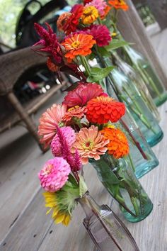 several vases filled with different colored flowers on a table