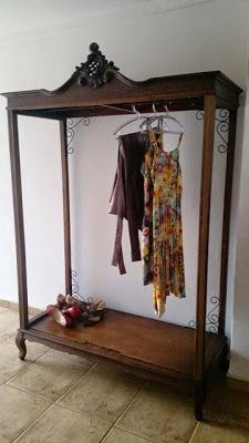 a coat rack with clothes hanging on it