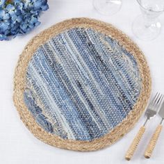 a place setting with blue flowers and silverware