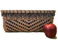 an apple sitting next to a woven basket