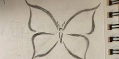 a pencil drawing of a butterfly on paper