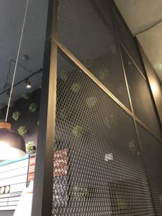 the interior of a restaurant with metal mesh walls