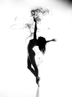 black and white photograph of a woman dancing in the air with her arms stretched out