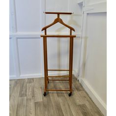 a wooden coat rack with a hanger on it