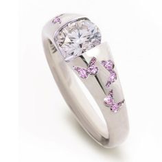 a white gold ring with pink diamonds and butterflies on the side, set in 18k white gold