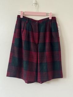 Hello there vintage lovers! This listing is for a pair of vintage high waisted plaid shorts. Dark tartan gives it a pink feel. Please see measurements for the sizing. Bermuda style and super high waisted. They have pockets! size x-small or Small based on measurements. Material is wool.  Measurements: 13" waist 21" long 12" rise  9" inseam.  Condition: Excellent Vintage Condition. No holes or damage that I can tell. This is a vintage piece. You will most likely not find another. Thank you for you Plaid Short Bottoms For Fall, Vintage Wide Leg Plaid Bottoms, High Waist Red Shorts For Fall, Vintage Bermuda Bottoms With Pockets, Retro Short Bottoms For Fall, Retro Plaid Bottoms With Pockets, Vintage High Waist Plaid Bottoms, Retro Plaid Short-length Bottoms, Retro Plaid Short Bottoms