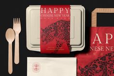 an assortment of chinese new year's eve items including napkins, forks and spoons