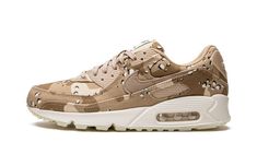 The Women’s Nike Air Max 90 “Desert Camo” is a women’s-exclusive colorway of the retro performance running shoe with an all-over camouflage look.  A September 2022 release by Nike, the Air Max 90 “Desert Camo” features the hard-to-miss camo print in an all-over pattern on its upper, including on the toe, mid-panel, collar, heel, and overlays.  A brown canvas Swoosh appears on either side of the shoe and continues the colorway’s military vibe.  Additional brown accents include a brown “Air Max” b Nike X Travis Scott, Camo Shoes, Desert Camo, Jordans Women, Jordan 2, Nike Air Max For Women, Print Shoes, Womens Jordans, Yeezy Shoes