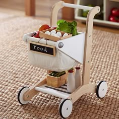 a toy wagon filled with food on top of a rug