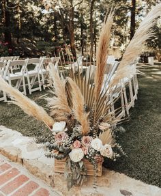 an outdoor ceremony setup with pamodia, pamodia grass and white flowers