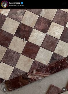 a close up of a tile floor with brown and white squares on it's surface