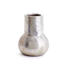 a silver vase sitting on top of a white surface