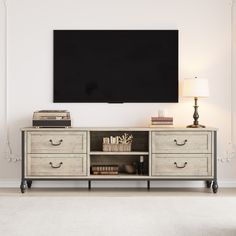 an entertainment center with a large flat screen tv mounted on it's sideboard