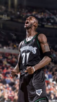 a basketball player with his mouth wide open in front of an arena full of people