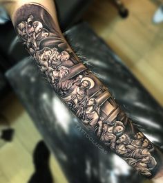 a man's arm with an image of the last supper tattoo on his forearm