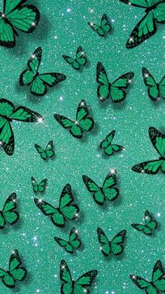 many green butterflies flying through the air on a glittery blue background with sparkle flecks