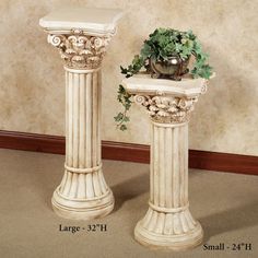 two white pedestals with plants in them