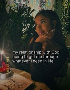 a woman sitting at a table in front of a cake with candles on it and the words, my relationship with god going to get me through whatever i need in life