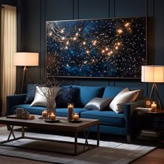 a living room filled with blue couches next to a painting on the wall and two lamps