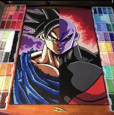 the dragon ball painting is being displayed in front of other paint colors and brushes on display