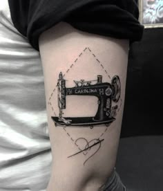 a tattoo with a sewing machine on it