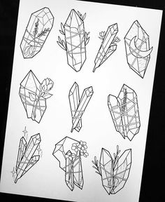 a drawing of different shapes and sizes of flowers on a piece of paper with black ink