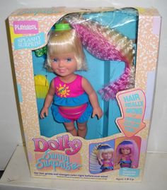 the doll has blonde hair and is in its box