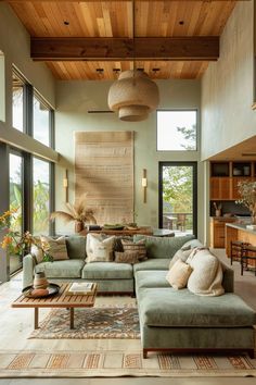 a living room filled with lots of furniture and large windows on top of the ceiling