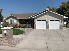 a house with two garages in front of it