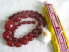 a red necklace next to a tube of toothpaste