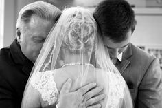 a man and woman hug each other as they are dressed in black and white for their wedding