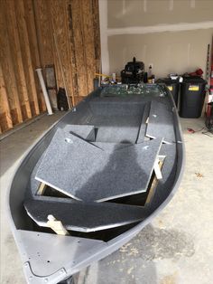 the inside of a boat being built in a garage