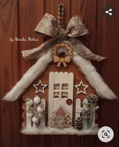 a house made out of wood and decorated with snowflakes, pine cones, and other decorations