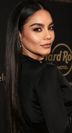 an image of a woman with long hair and black dress on the red carpet in front of a wall