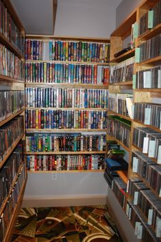 a room filled with lots of dvds and video game cases next to eachother