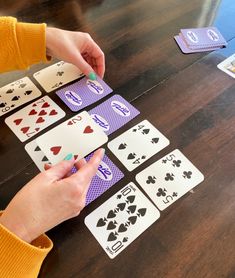 a person is playing cards on a table