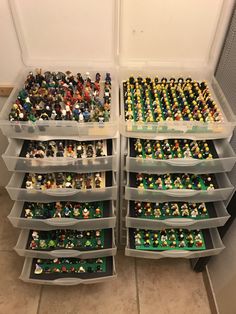 two plastic containers filled with legos on top of a tiled floor next to each other